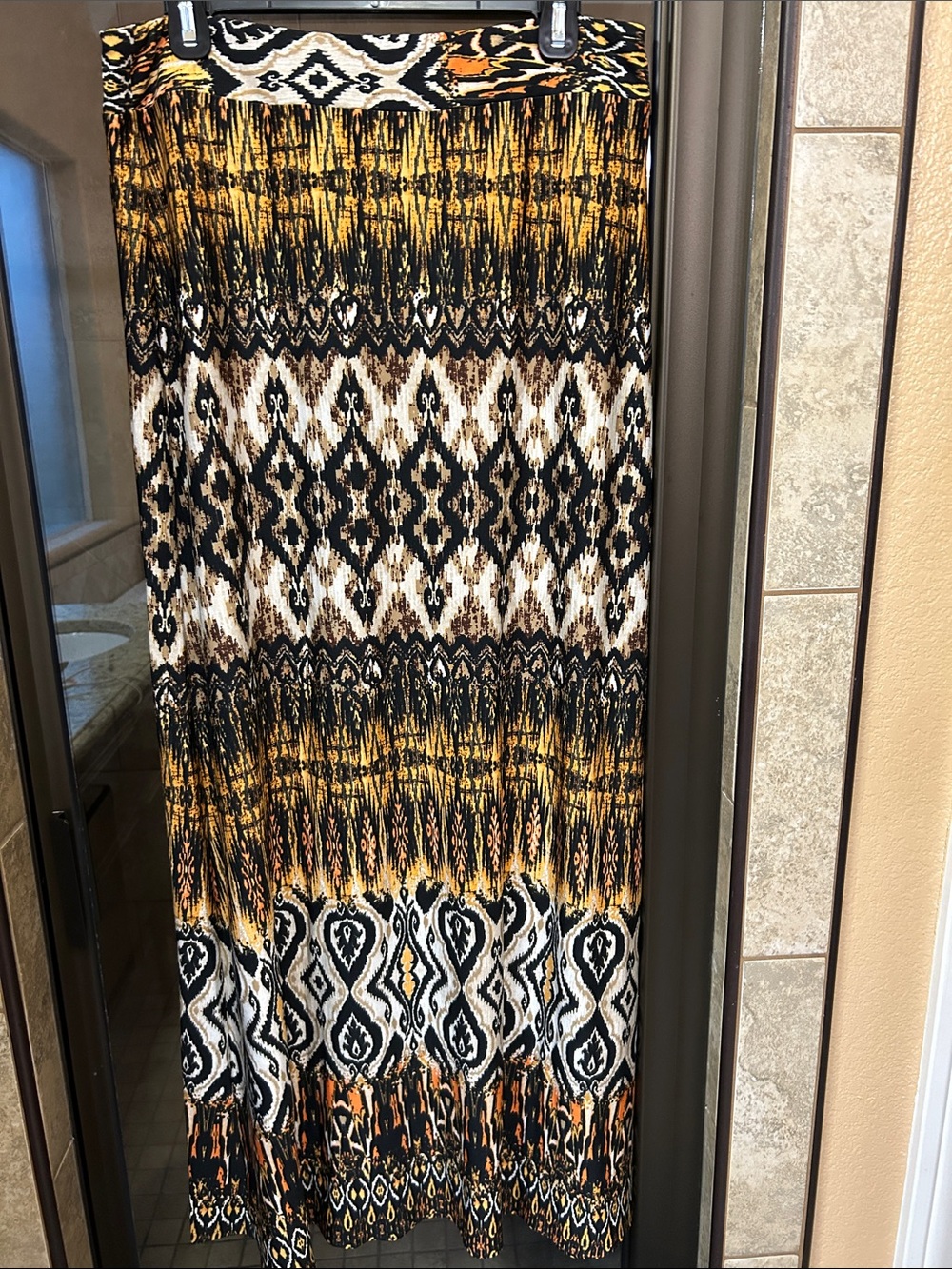 Soho Apparel Tribal Print Maxi Skirt in Black, White, Gold, Brown, and Orange.